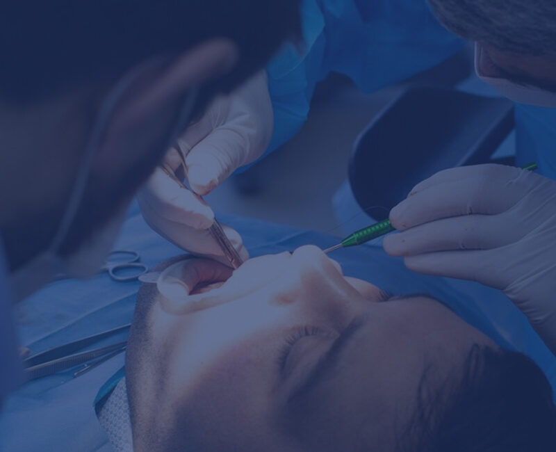 Dental professionals performing a teeth straightening surgery on a patient.