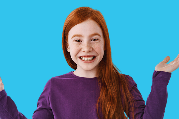 A girl with red hair is holding her hands out in front of a blue background.