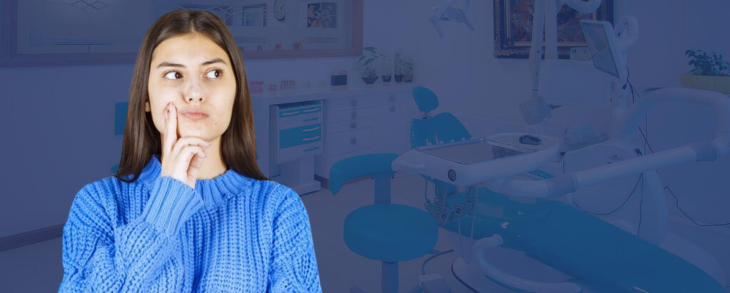 A woman is standing in front of a dental office, considering wearing teeth straighteners and wondering how they work.