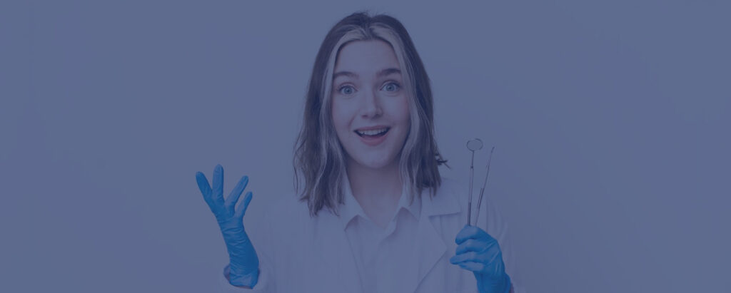 Dentist in scrubs holding clear aligners with a surprised expression.