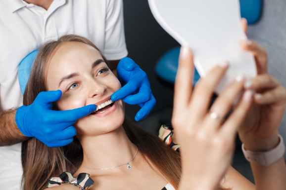 A woman is receiving clear aligner treatment for her deep bite teeth from a dentist.